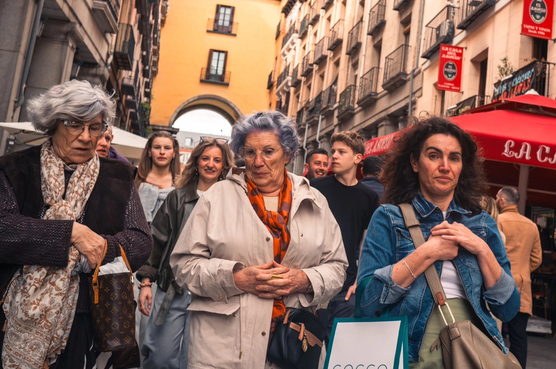 A group of women on a narrow street in Madrid.
